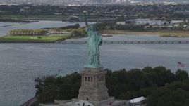 4K aerial stock footage Flying by the Statue of Liberty, Liberty Island, New York, New York Aerial Stock Footage | AX87_007
