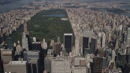 4K aerial stock footage Tilt up from Midtown skyscrapers, revealing Central Park, New York, New York Aerial Stock Footage | AX87_079