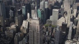 4K aerial stock footage Flying by top of Empire State Building, Midtown Manhattan skyscrapers, New York Aerial Stock Footage | AX87_112