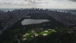 4K aerial stock footage Flying by Central Park, seen from Harlem, New York, New York Aerial Stock Footage | AX87_131