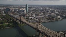 4K aerial stock footage flying by Queensboro Bridge spanning East River, Queens, New York, New York Aerial Stock Footage | AX87_189