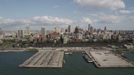 4K aerial stock footage of flying by piers and skyscrapers, seen from East River, Brooklyn, New York Aerial Stock Footage | AX88_002