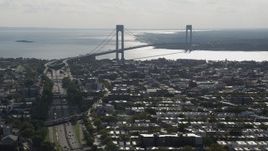 4K aerial stock footage of the Verrazano-Narrows Bridge, seen from Brooklyn row houses, New York Aerial Stock Footage | AX88_030