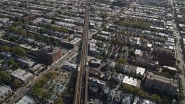 4K aerial stock footage of flying by railroad tracks and row houses, Brooklyn, New York Aerial Stock Footage | AX88_034
