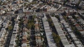 4K aerial stock footage video of flying over neighborhoods and tilting to row houses, Brooklyn, New York Aerial Stock Footage | AX88_036