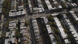 4K aerial stock footage of following railroad tracks through an urban neighborhood, Brooklyn, New York Aerial Stock Footage | AX88_039
