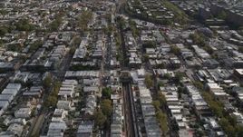 4K aerial stock footage of following railroad tracks and flying over urban neighborhoods, Brooklyn, New York Aerial Stock Footage | AX88_040