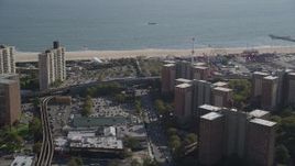 4K aerial stock footage flyby apartment buildings toward the beach, Luna Park in Coney Island, Brooklyn, New York Aerial Stock Footage | AX88_042