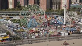 4K aerial stock footage flyby Luna Park Ferris wheel, revealing roller coaster, Coney Island, Brooklyn, New York Aerial Stock Footage | AX88_048