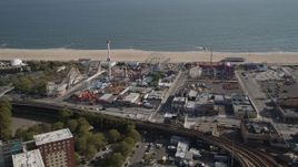 4K aerial stock footage of flying away from rides and beach at Luna Park, Coney Island, Brooklyn, New York Aerial Stock Footage | AX88_059