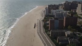 4K aerial stock footage of flying by Coney Island Beach and boardwalk in Brooklyn, New York, New York Aerial Stock Footage | AX88_061