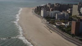 4K aerial stock footage of flying by Coney Island Beach and boardwalk in Brooklyn, New York Aerial Stock Footage | AX88_062