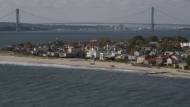 4K aerial stock footage of passing by beachfront homes in Coney Island, Brooklyn, New York, New York Aerial Stock Footage | AX88_067