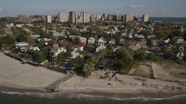 4K aerial stock footage of flying by homes near the beach in Coney Island, Brooklyn, New York, New York Aerial Stock Footage | AX88_072