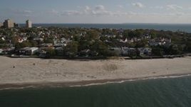 4K aerial stock footage of flying away from homes on the beach in Coney Island, Brooklyn, New York, New York Aerial Stock Footage | AX88_073