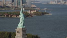 4K aerial stock footage of flying by Statue of Liberty, with Ellis Island in background, New York, New York Aerial Stock Footage | AX88_098