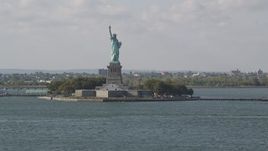 4K aerial stock footage tilt from New York Harbor, revealing Statue of Liberty, New York, New York Aerial Stock Footage | AX88_102