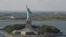 4K aerial stock footage tilt from New York Harbor, revealing Statue of Liberty, New York, New York Aerial Stock Footage | AX88_103