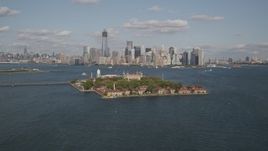 4K aerial stock footage of flying by Ellis Island, Lower Manhattan skyline in background, New York, New York Aerial Stock Footage | AX88_111