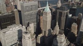 4K aerial stock footage video of approaching 40 Wall Street in Lower Manhattan, New York, New York Aerial Stock Footage | AX88_118