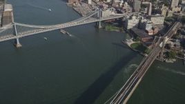 4K aerial stock footage pan from Manhattan Bridge to famous Brooklyn Bridge, East River, New York, New York Aerial Stock Footage | AX88_121
