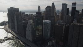 4K aerial stock footage of flying by Lower Manhattan skyscrapers, seen from East River, New York, New York Aerial Stock Footage | AX88_142