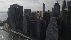 4K aerial stock footage of flying by waterfront skyscrapers by East River, Lower Manhattan, New York, New York Aerial Stock Footage | AX88_143