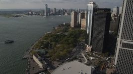 4K aerial stock footage of approaching Battery Park by skyscrapers in Lower Manhattan, New York, New York Aerial Stock Footage | AX88_145