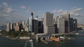 4K aerial stock footage of passing by Battery Park, ferry terminal, and riverfront skyscrapers in Lower Manhattan, New York, New York Aerial Stock Footage | AX88_160