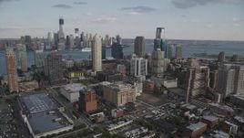 4K aerial stock footage of city skyscrapers and Lower Manhattan skyline in background, Downtown Jersey City, New Jersey Aerial Stock Footage | AX88_171