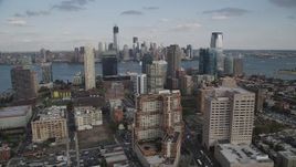 4K aerial stock footage of city skyscrapers and Lower Manhattan skyline in background, Downtown Jersey City, New Jersey Aerial Stock Footage | AX88_172