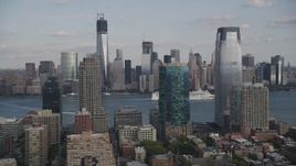 4K aerial stock footage of cruise ship passing Lower Manhattan skyscrapers, seen from Downtown Jersey City, New Jersey Aerial Stock Footage | AX88_173