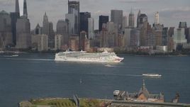 4K aerial stock footage of a cruise ship sailing past Lower Manhattan skyline, New York, New York Aerial Stock Footage | AX88_175