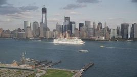 4K aerial stock footage of tracking a cruise ship sailing by skyline of Lower Manhattan, New York, New York Aerial Stock Footage | AX88_176