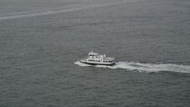 4K aerial stock footage of tracking a small ferry sailing New York Harbor, New York, New York Aerial Stock Footage | AX88_182