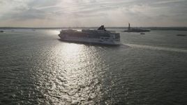 4K aerial stock footage of flying by cruise ship sailing near the Statue of Liberty, New York Aerial Stock Footage | AX88_191