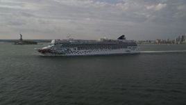 4K aerial stock footage of a cruise ship sailing New York Harbor near Statue of Liberty, New York, New York Aerial Stock Footage | AX88_192
