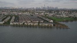 4K aerial stock footage of flying by waterfront condominiums, Lower Manhattan skyline in background, Jersey City, New Jersey Aerial Stock Footage | AX88_202