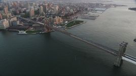 4K aerial stock footage Flying by Brooklyn Bridge, East River, New York, New York, sunset Aerial Stock Footage | AX89_009