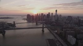 4K aerial stock footage Fly over East River, reveal Lower Manhattan, Bridges, New York, sunset Aerial Stock Footage | AX89_012
