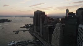 4K aerial stock footage Flying by Lower Manhattan, Staten Island Ferry, New York, New York, sunset Aerial Stock Footage | AX89_017