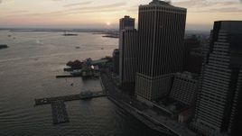 4K aerial stock footage Flying by Staten Island Ferry, New York Harbor, Lower Manhattan, New York, sunset Aerial Stock Footage | AX89_018