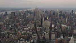 4K aerial stock footage Flying by Midtown Manhattan, Empire State Building, New York, New York, twilight Aerial Stock Footage | AX89_040