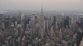 4K aerial stock footage Flying by Empire State Building, Midtown Manhattan, New York, New York, twilight Aerial Stock Footage | AX89_041