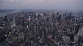4K aerial stock footage Approaching Midtown Manhattan, Empire State Building, New York, twilight Aerial Stock Footage | AX89_080