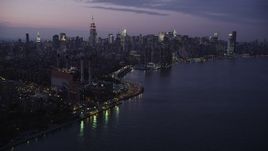 4K aerial stock footage Flying by Midtown Manhattan, seen from East River, New York, New York, twilight Aerial Stock Footage | AX89_113