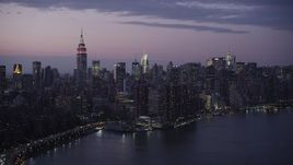 4K aerial stock footage Flying by Midtown Manhattan, seen from East River, New York, New York, twilight Aerial Stock Footage | AX89_114