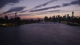 4K aerial stock footage Flying by Manhattan Bridge, Lower Manhattan skyline, New York, twilight Aerial Stock Footage | AX89_126
