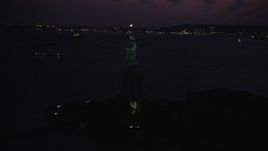 4K aerial stock footage Flying by Statue of Liberty, Liberty Island, New York, New York, twilight Aerial Stock Footage | AX89_137
