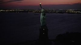 4K aerial stock footage Flying by the Statue of Liberty, Liberty Island, New York, New York, twilight Aerial Stock Footage | AX89_138